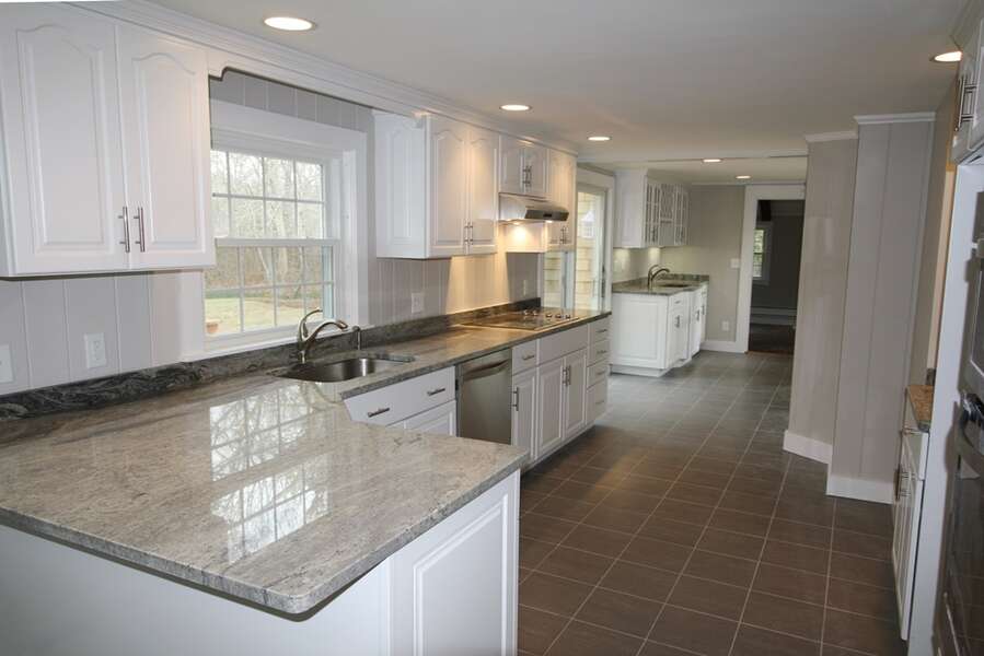 Kitchen with granite counter tops and stainless steel appliances - 4 Long Pond Drive Harwich Cape Cod New England Vacation Rentals-#BookNEVRDirectCapeRetreat