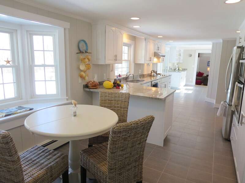 View of breakfast nook (seating for 4) and kitchen into great room - 4 Long Pond Drive Harwich Cape Cod New England Vacation Rentals-#BookNEVRDirectCapeRetreat