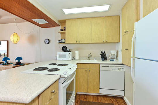 Kitchen with Counter, Refrigerator, Coffee Maker, Microwave, and Dishwasher.
