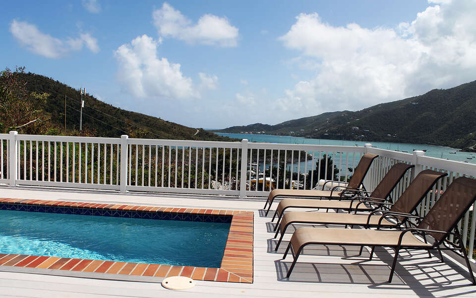 Lounge in sun with views of Coral Bay and a refreshing dip in the pool
