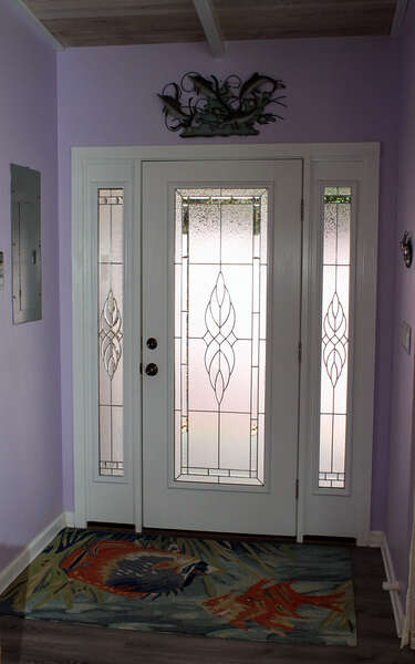 Welcoming foyer with custom glass on door