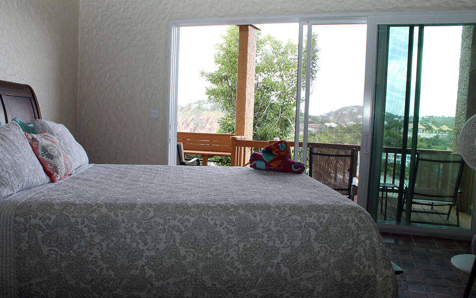 Bedroom with view to outside balcony