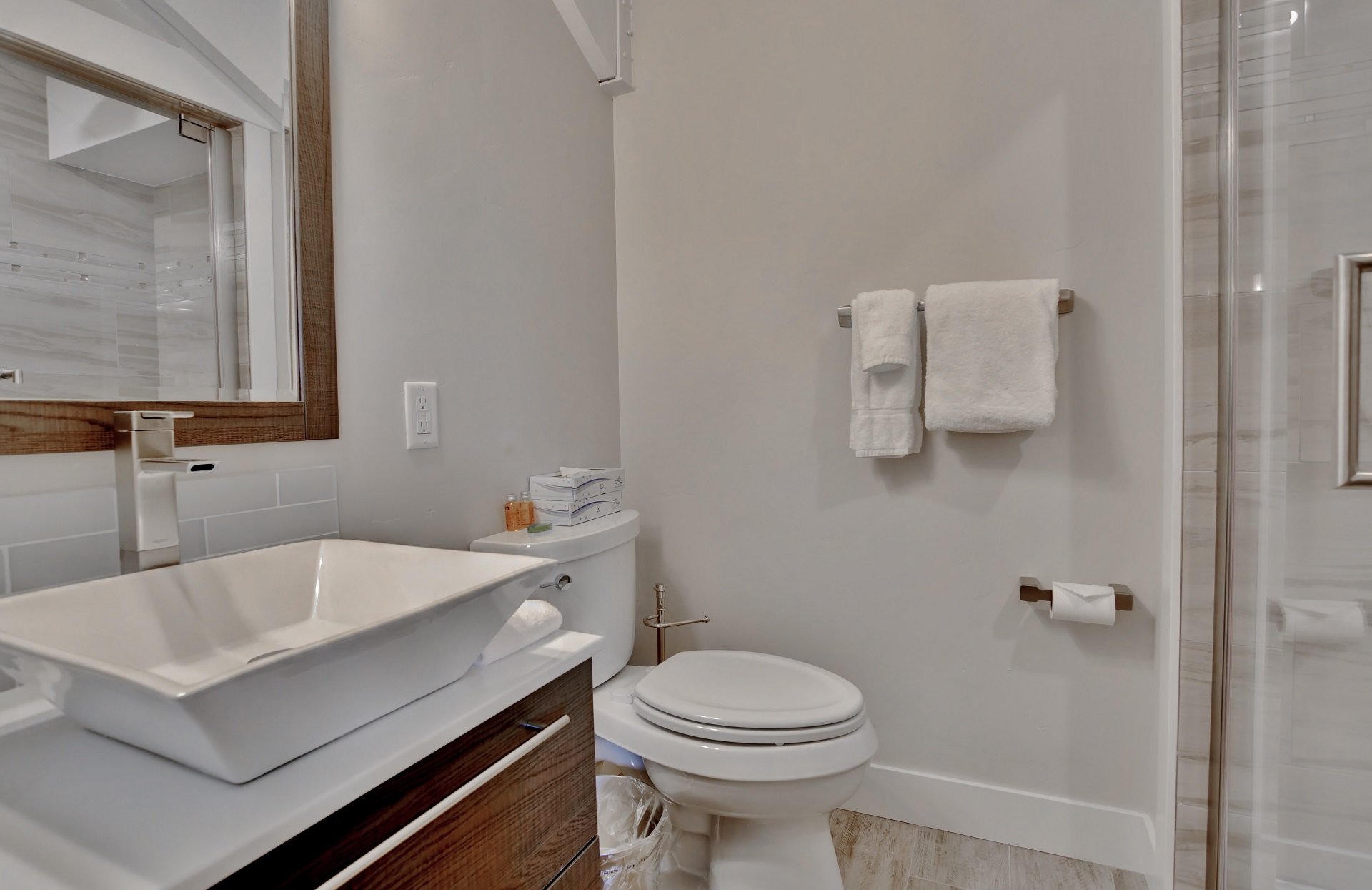 Top floor master bathroom with rainwater tile/stone shower and raised vessel vanity