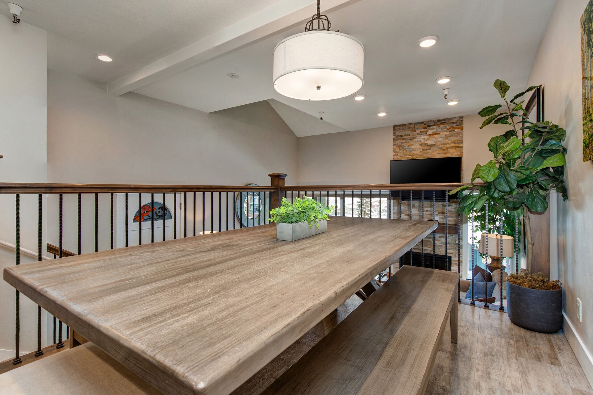 Dining room with 8-10 seat custom dining table and two long bench seats