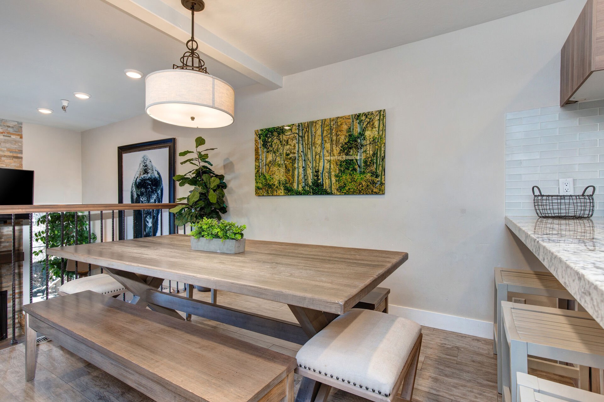 Dining room with 8-10 seat custom dining table and two long bench seats