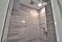 Top floor master bathroom with rainwater tile/stone shower and raised vessel vanity
