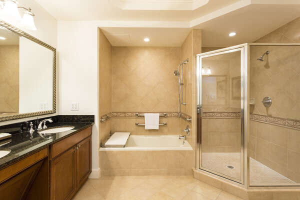The master bathroom offers his and hers sinks, large soaker tub and separate shower