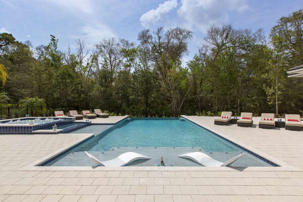 The privacy of this home is one-of-a-kind with simply nature surrounding your outdoor entertainment area and pool deck