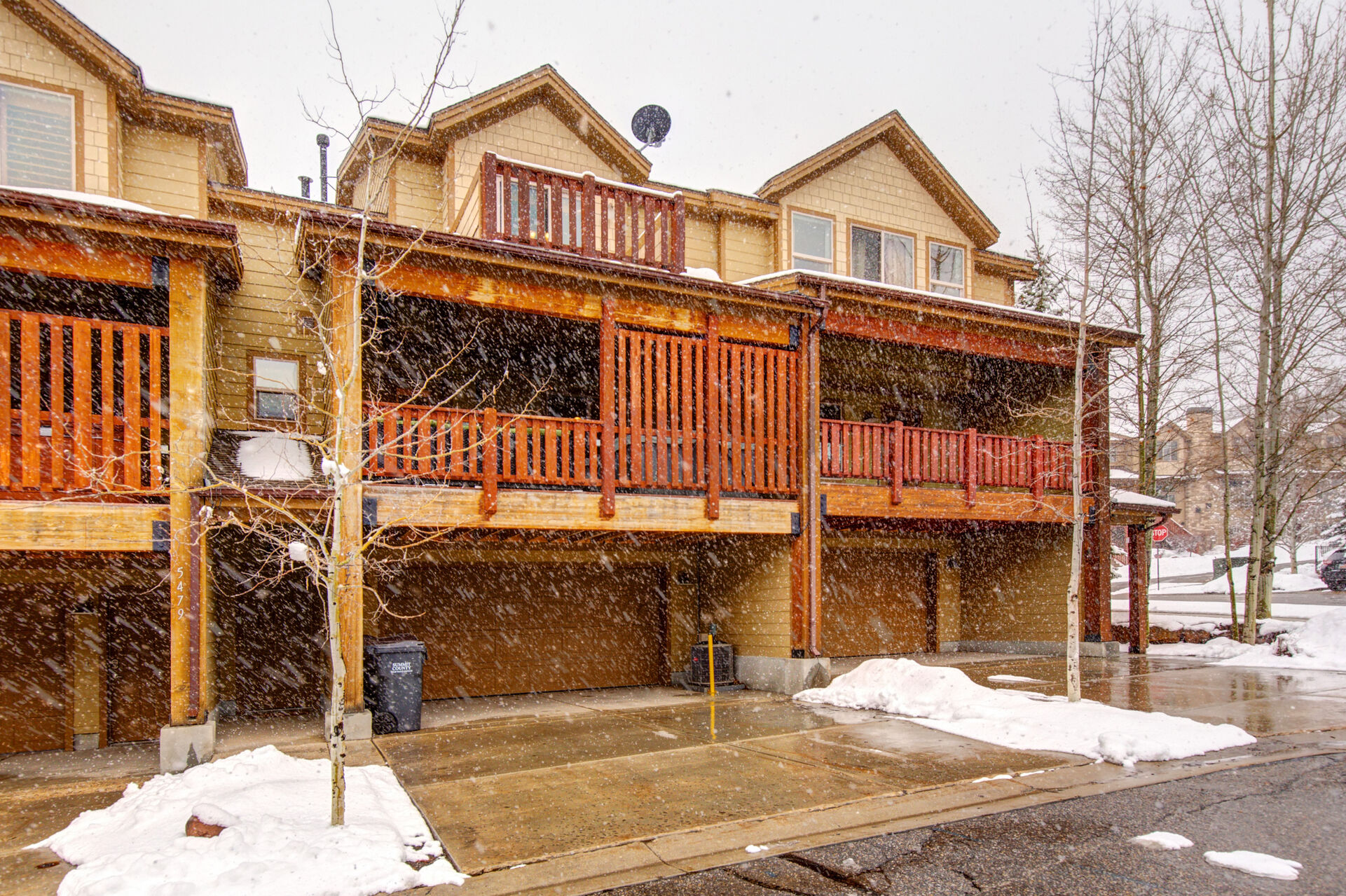 Rear Exterior.  2 parking spots available in driveway, first come first serve parking on the road., Main Level Private Deck with Patio Seating, a BBQ and Hot Tub, and Master Bedroom Private Deck