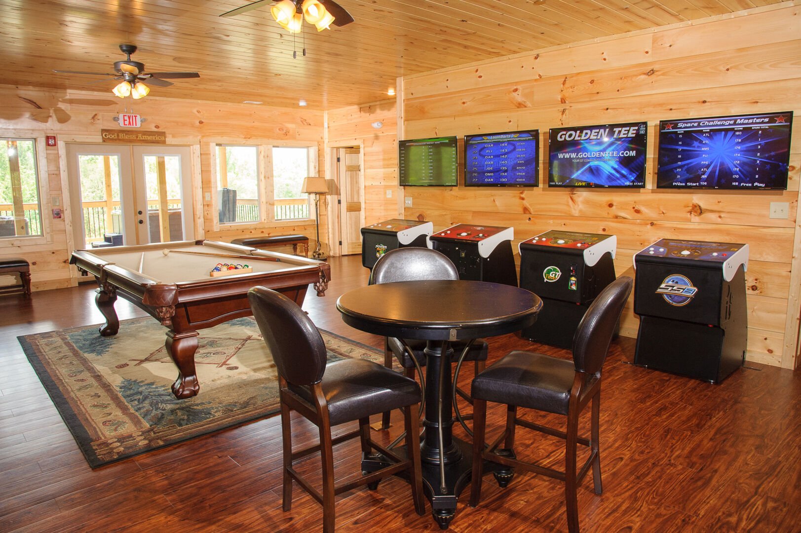 Game room with seating, arcade cabinets, and a pool table.