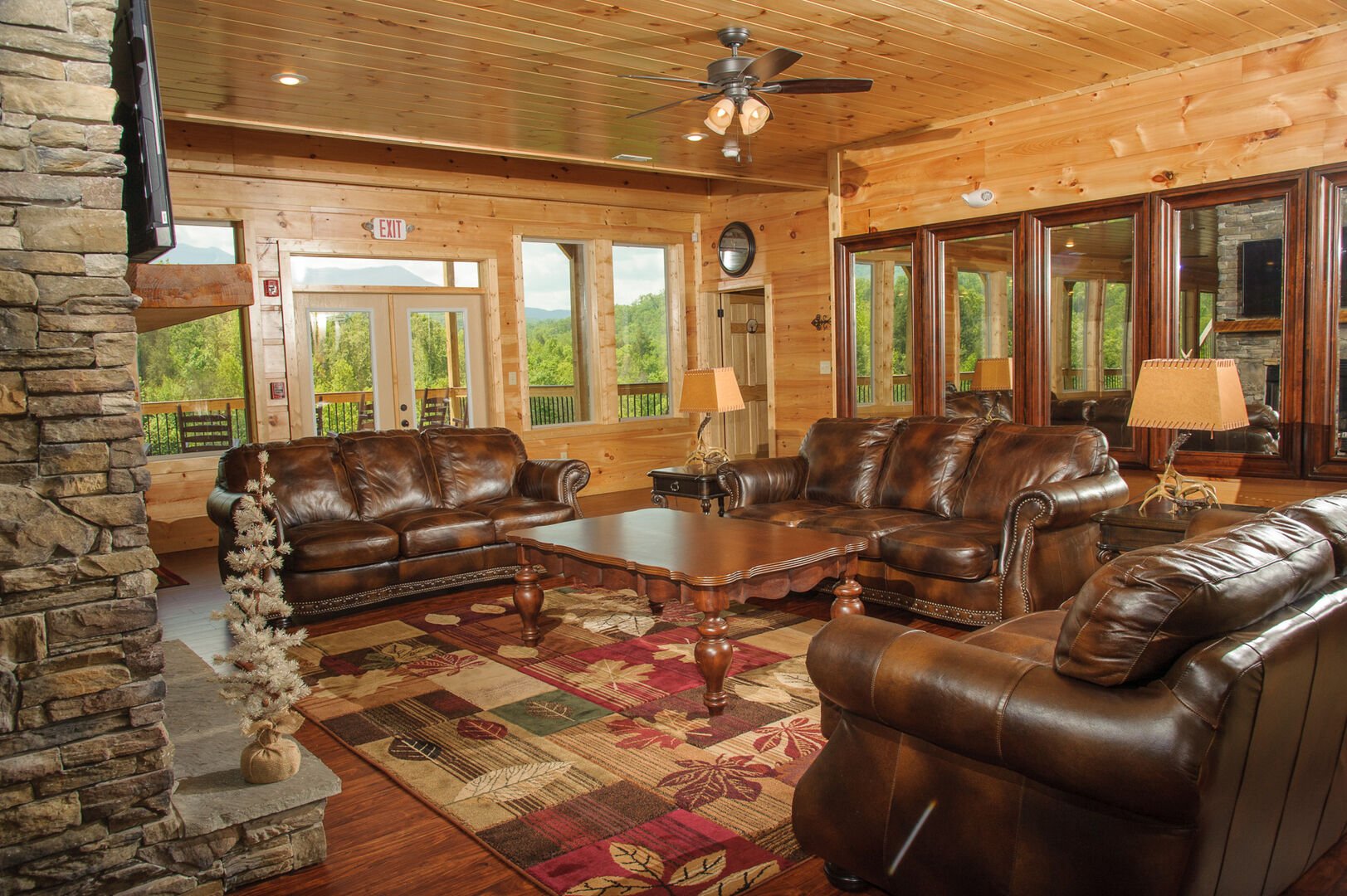 Living area with leather couches and ornate coffee table.