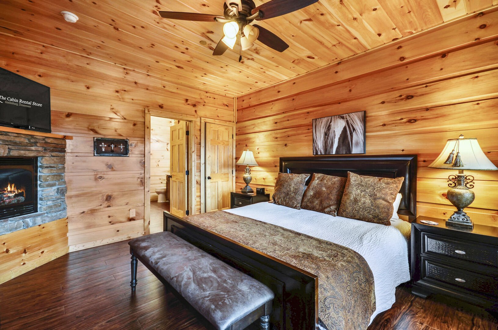 Fireplace, large bed, and nightstands in a bedroom of this Vacation rental near Gatlinburg TN.