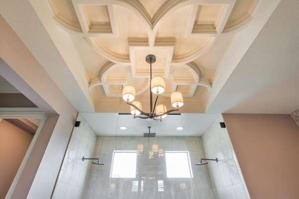 The ornate vaulted ceiling in master suite bathroom 1 adds a hint of Mediterranean elegance