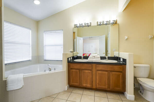 Master bathroom showing corner tub and his n hers vanities.  There is also a separate shower.