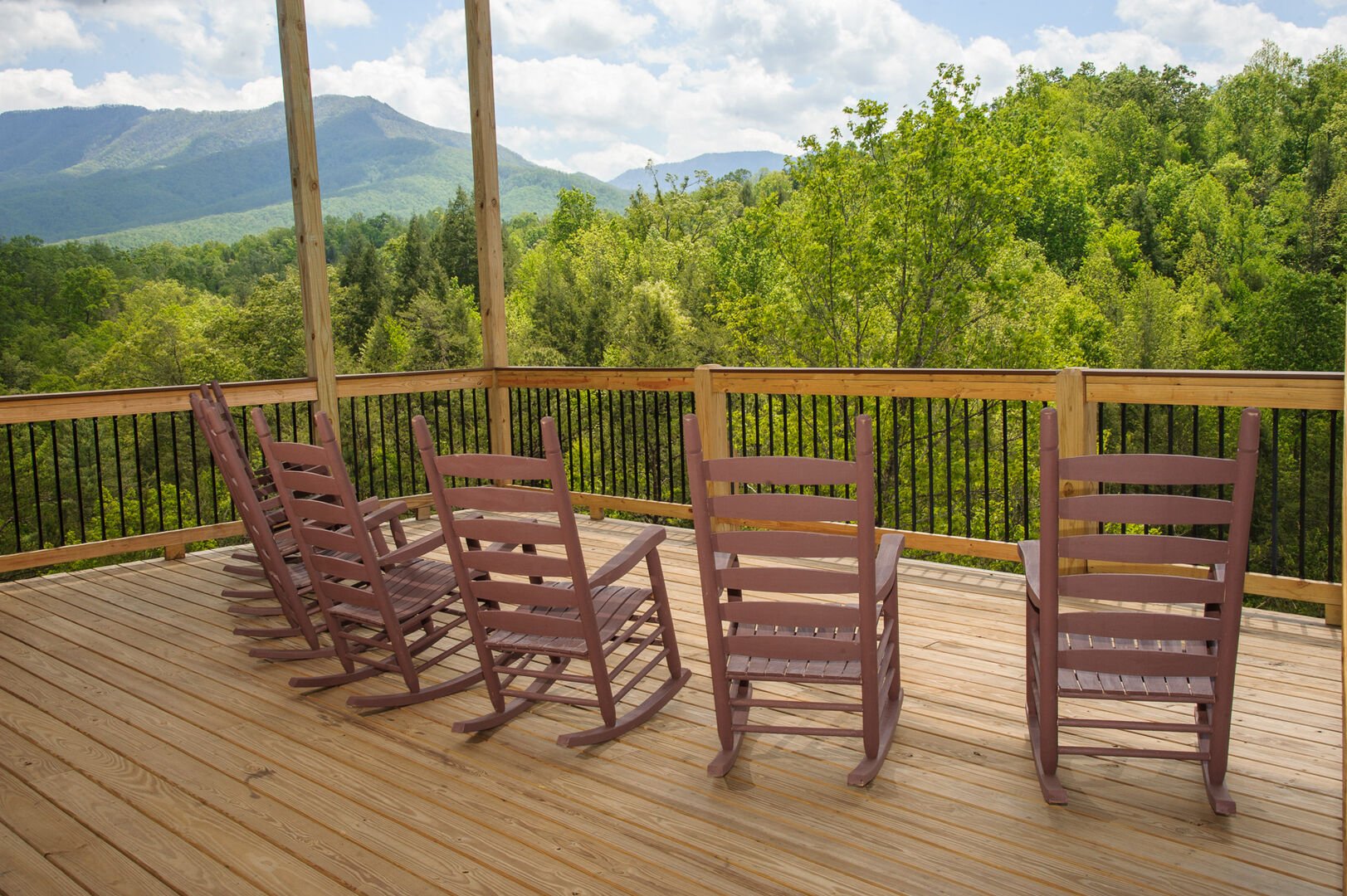 Many Rocking Chairs in the Deck with Mountain View.