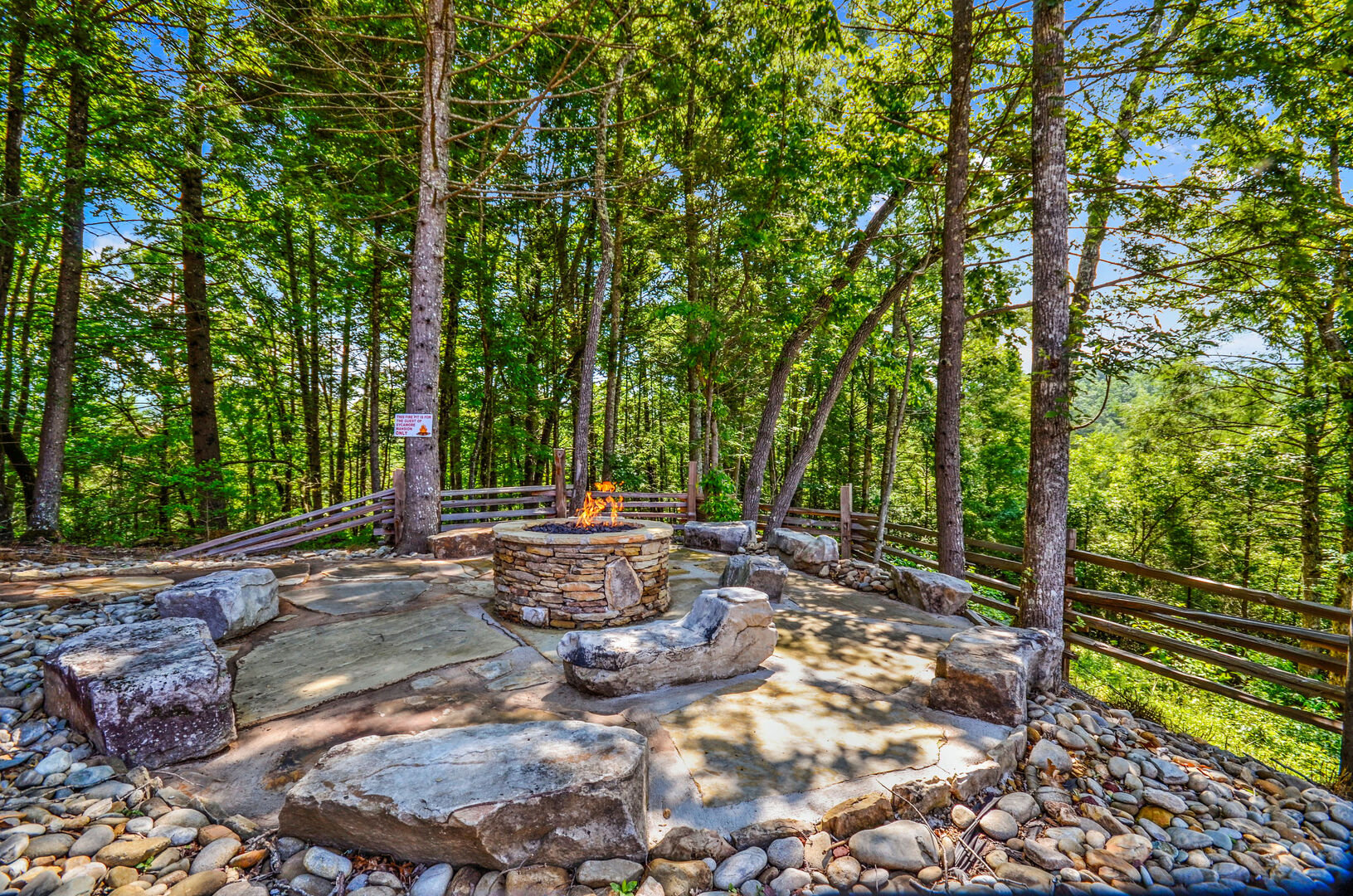 Gathering Area with Fire Pit, Rock Garden Benches, and Trees.