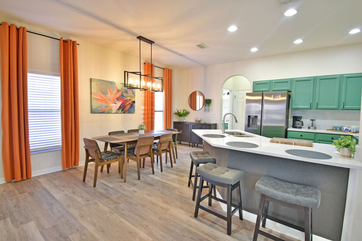 Kitchen and dining room showing breakfast bar seating