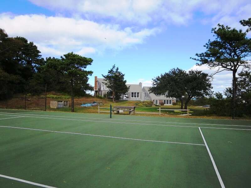 Play a round of tennis. Just steps across the yard from the house. Private court-play anytime. - 299 Cranberry Lane North Chatham Cape Cod New England Vacation Rentals   #BookNEVRDirectBarefootHome