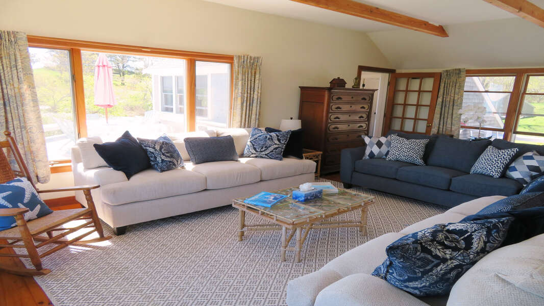 View of living room from Kitchen area- view out to deck-299 Cranberry Lane North Chatham Cape Cod New England Vacation Rental  #BookNEVRDirectBarefootHome