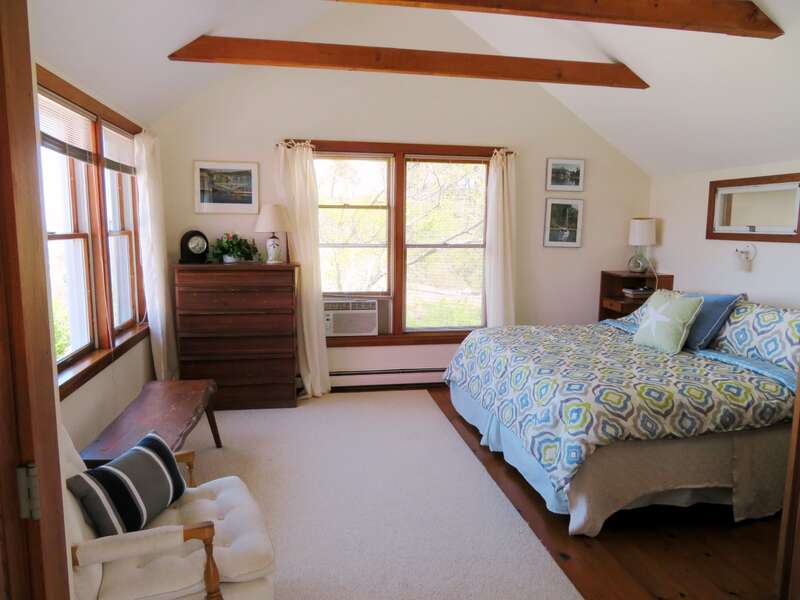 Master bedroom with King size bed off of main entry way-This bedroom offers great views!!-299 Cranberry Lane North Chatham Cape Cod New England Vacation Rentals  #BookNEVRDirectBarefootHome