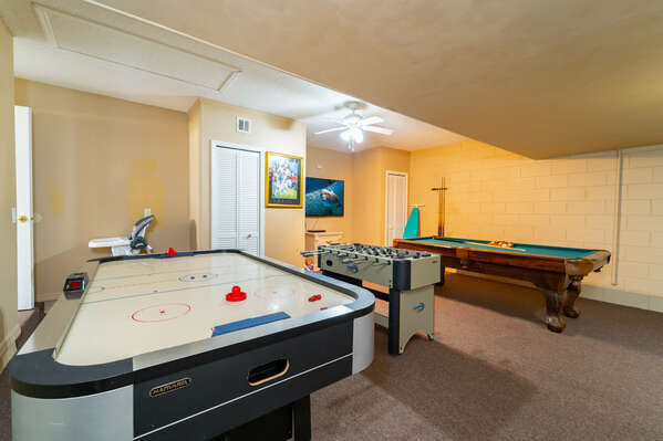 Garage converted to games room with air hockey, foosball and pool table