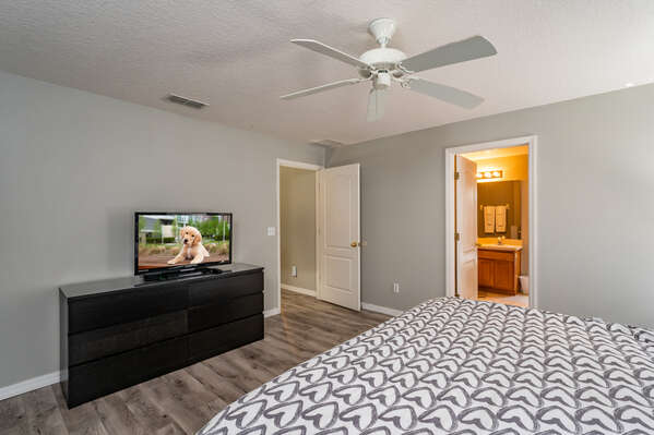 Master bedroom showing  TV and en suite bath