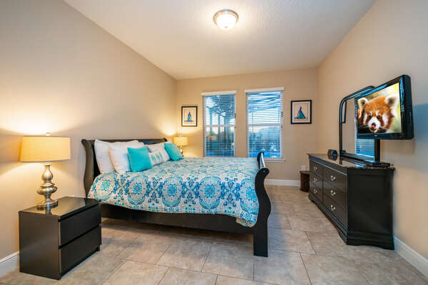 Master bedroom (downstairs) has king bed, flatscreen TV and pool view