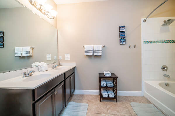 Master bedroom en-suite bathroom has bath/shower combo and double basins
