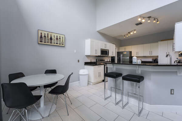 Eat in kitchen with 4seater dinette table and 2 stools at the breakfast bar