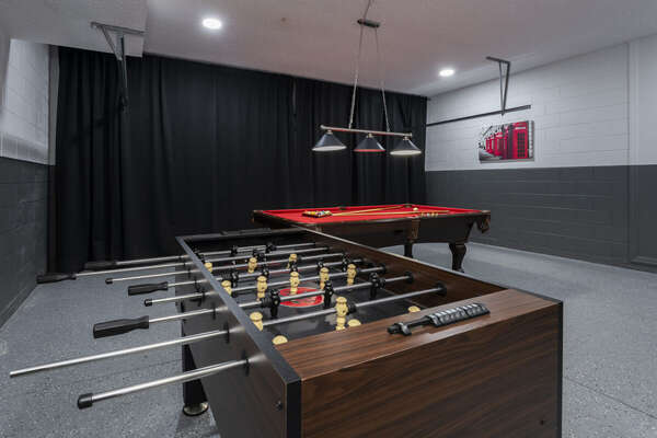 Game room showing billiards table and foosball table