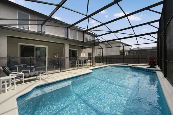 Swimming pool  view showing screen enclosure and safety fence