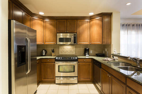 Granite counter tops and stainless appliances can be found in this beautiful kitchen