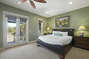 Green bedroom with ceiling fan