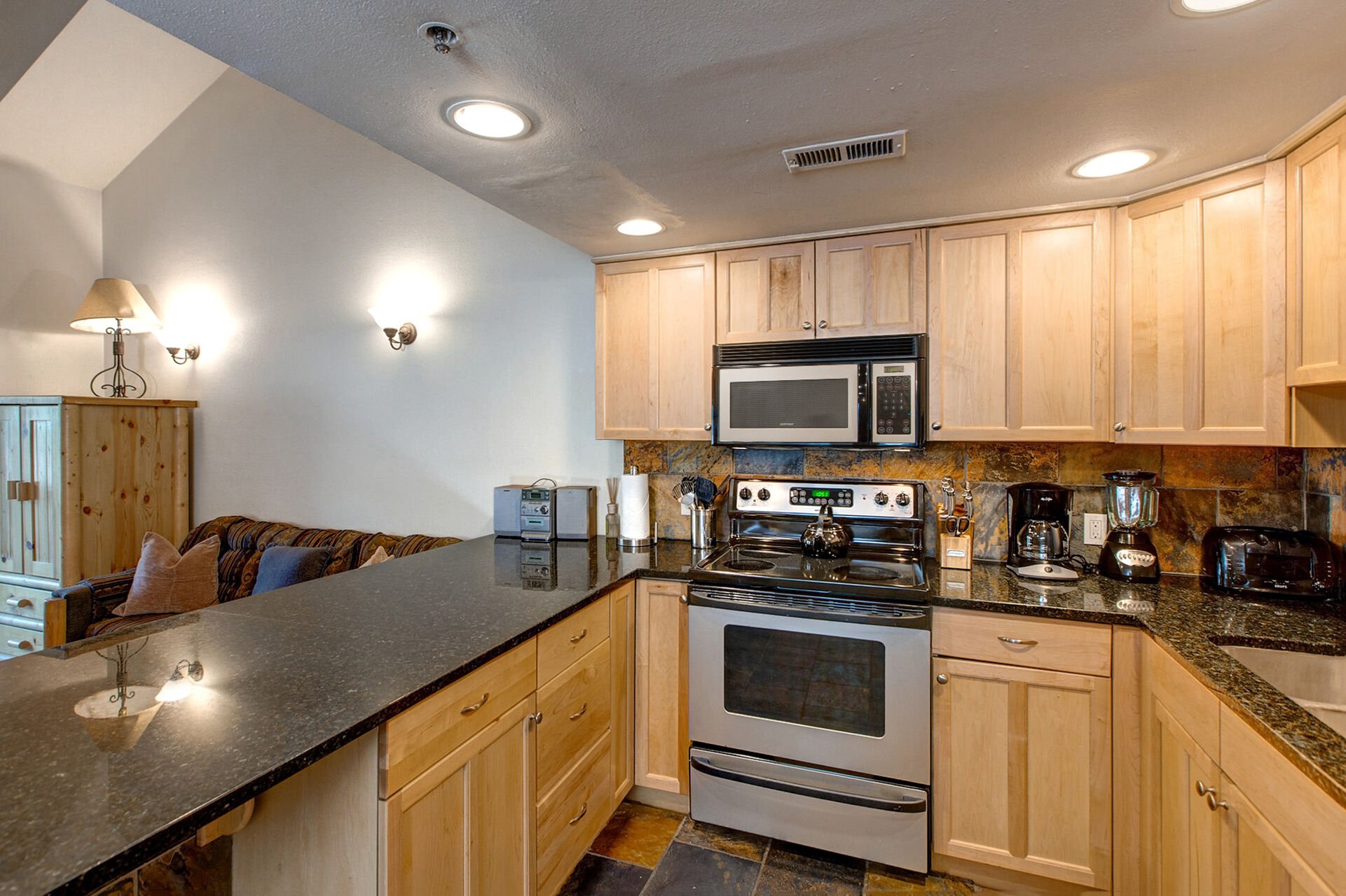 Fully Equipped Kitchen with Stainless Steel Appliances, Bar Seating for 4