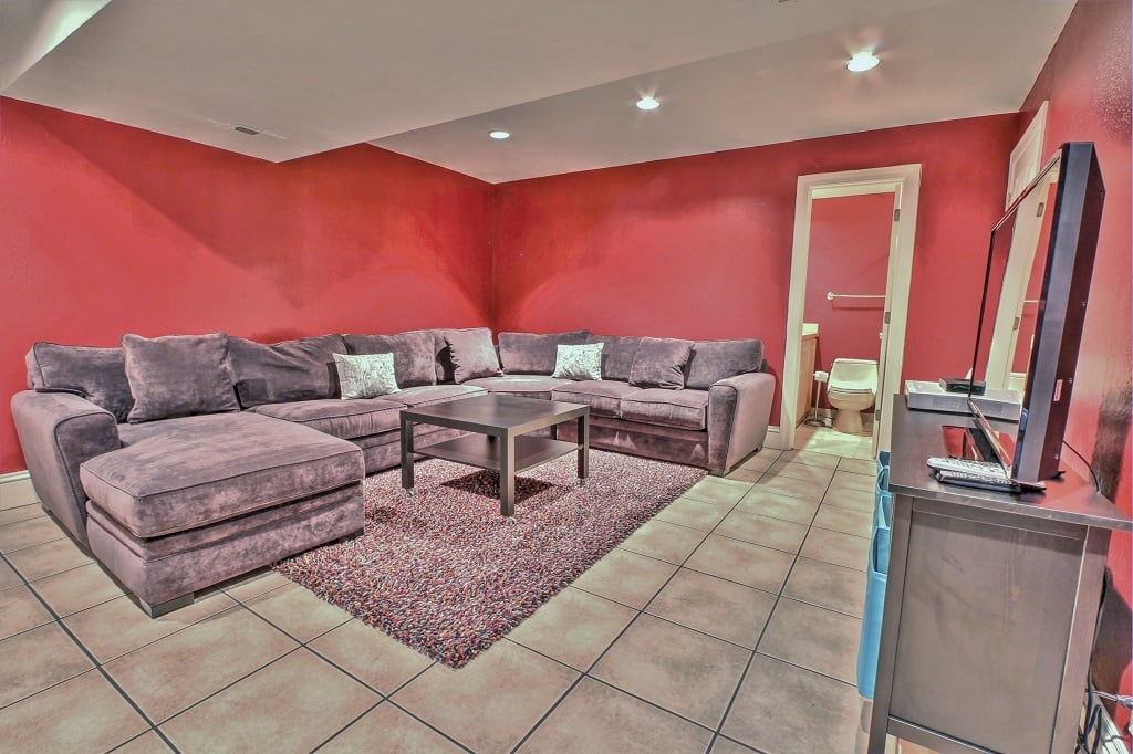 Lower level entertainment room with large HD TV and full bathroom