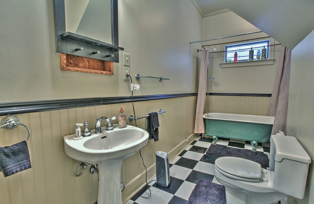 Main level full bathroom with claw-footed tub