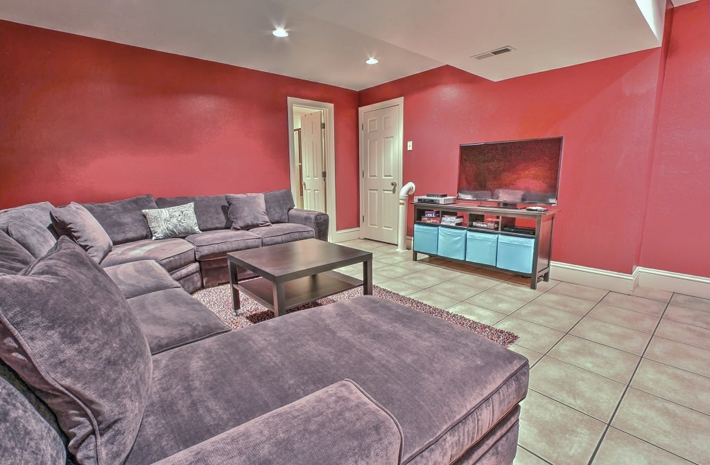 Lower level entertainment room with large HD TV and full bathroom