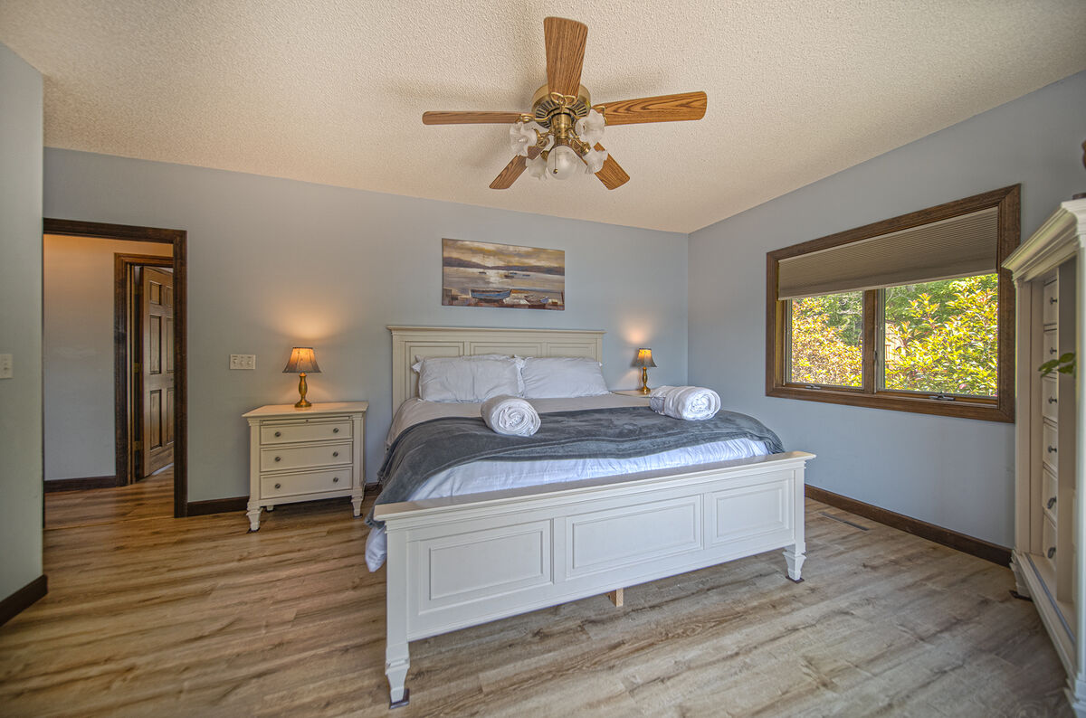 Master Bedroom Features Natural Light From Windows.