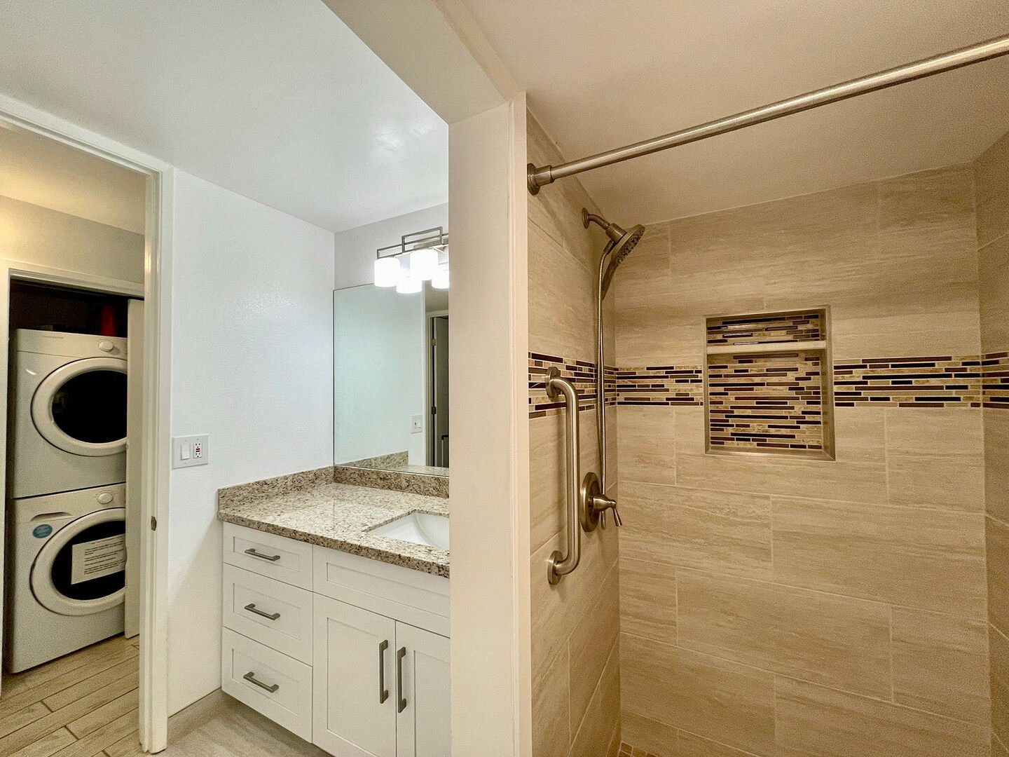 Bathroom with walk-in shower and in-unit washer and dryer