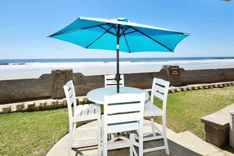 Ground level oceanfront cottage with bar height patio furniture for a perfect beach view