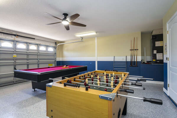 Garage converted game room showing pool and foosball tables.