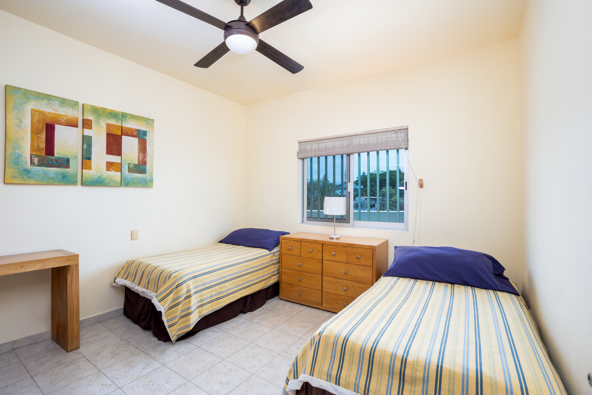 Guest room equipped with two single beds .
