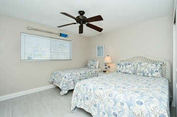 2nd Bedroom with queen plus twin-size beds, HDTV, large window overlooking bay and boat docks