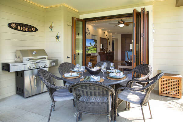 The front lanai of this Waikoloa Hawai'i vacation rental with table a and a grill.