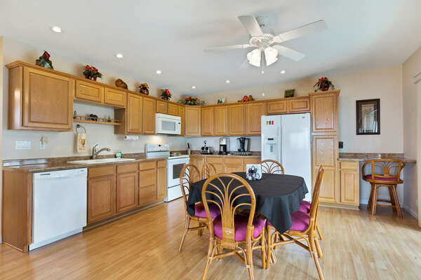 Kitchen and Dining Area with modern amenities and table.