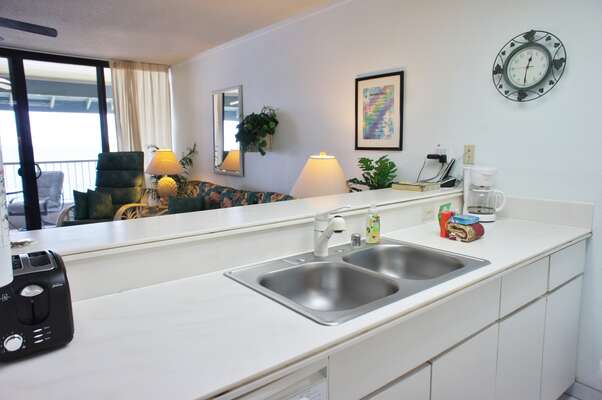 Kitchen counter with sink, toaster, and coffee maker