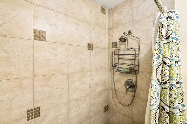 Primary bathroom Shower/Tub Combo with Floral Curtain