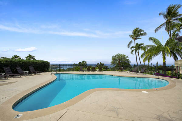Pool with Lounge Chairs and Ocean Views at Kona Hawaii Vacation Rentals