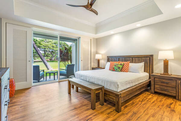 Bedroom with Large Bed, Ceiling Fan, and Sliding Doors to Lanai