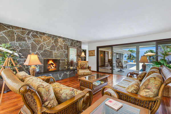 Living Area of this Kona Hawai'i vacation rental with ample seating and a fireplace in the center room.